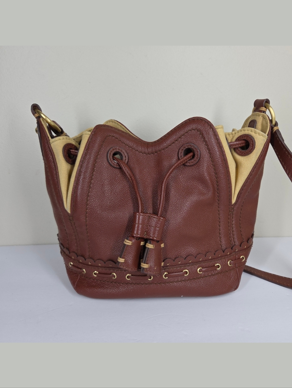Isabella Fiore Lotus Drawstring Bucket Bag Leather Brown Tan Grommet Boho